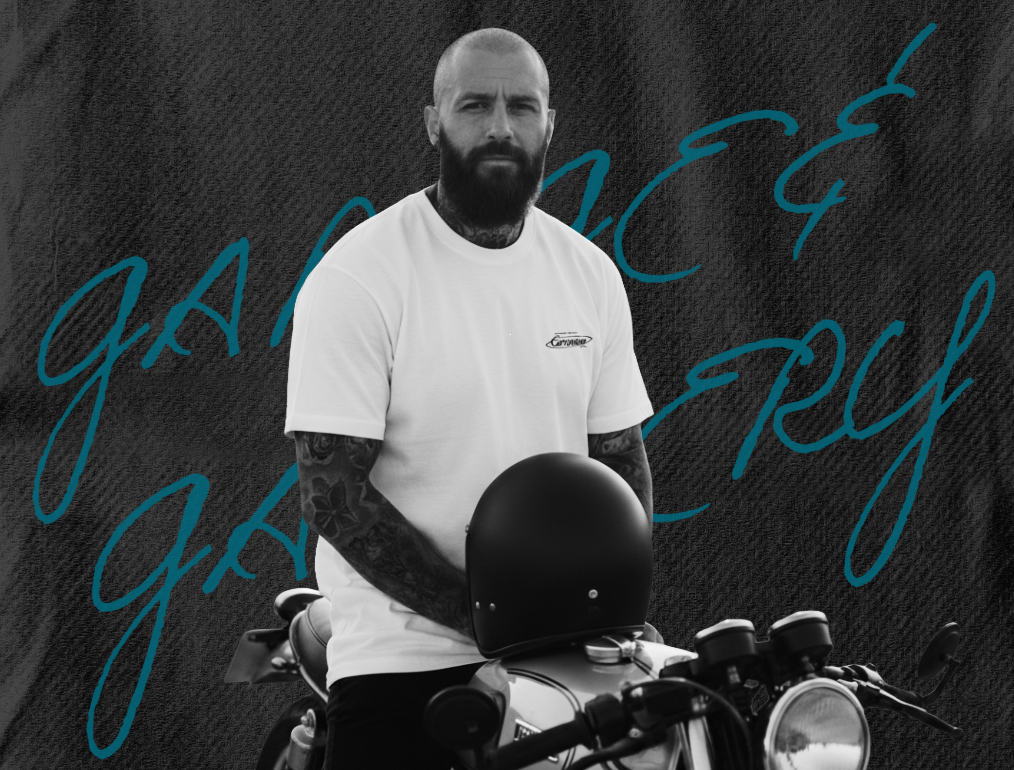 Campaign image of man sat on motorcycle  wearing Garage & Gallery tee